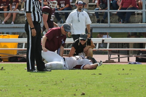 Chapman's athletic trainer attends to an injured football player.