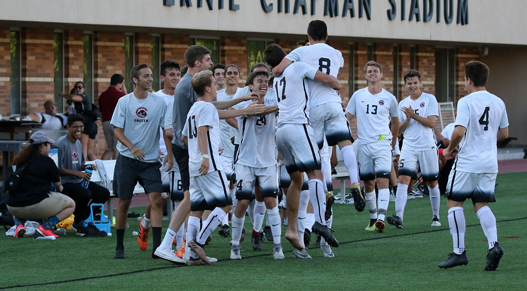 The Chapman sideline celebrated after Jonah Tipp scores a goal.