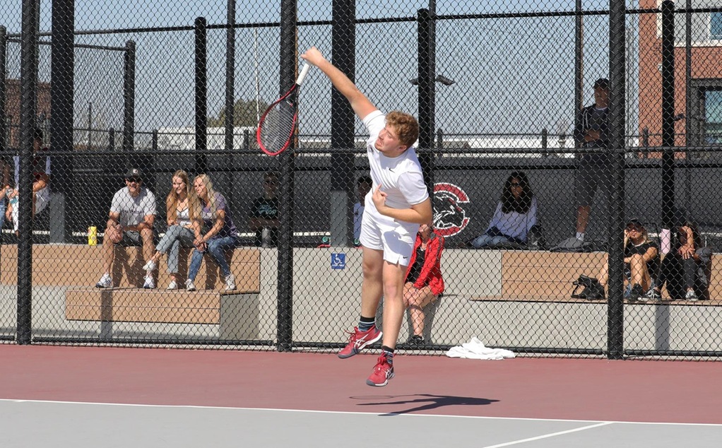 Steven Ferry serves in tennis.