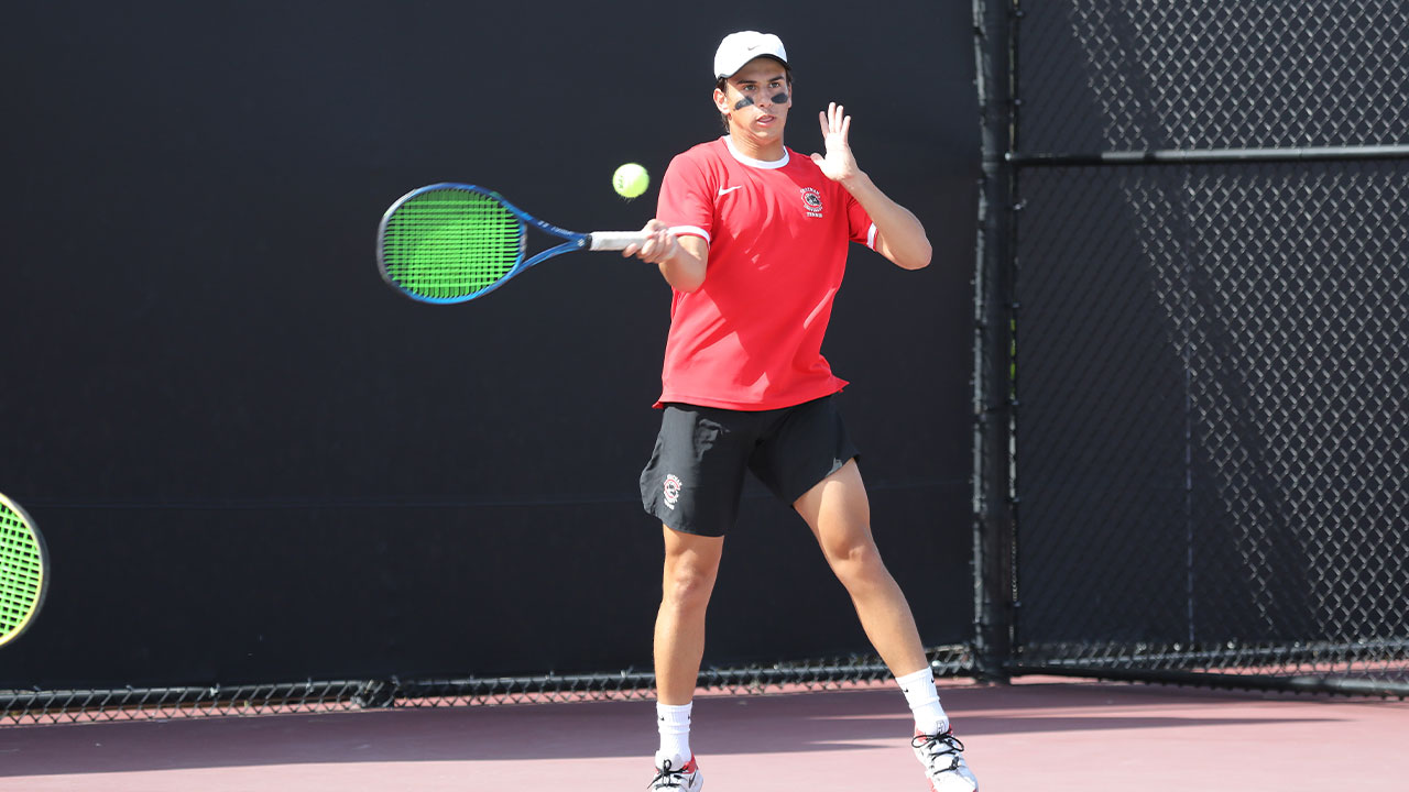 Alex Granados hits a tennis ball.