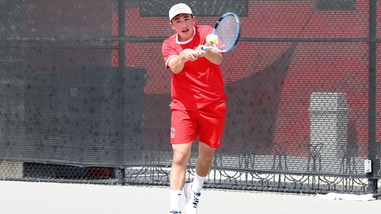 A tennis player connects in hitting a tennis ball.