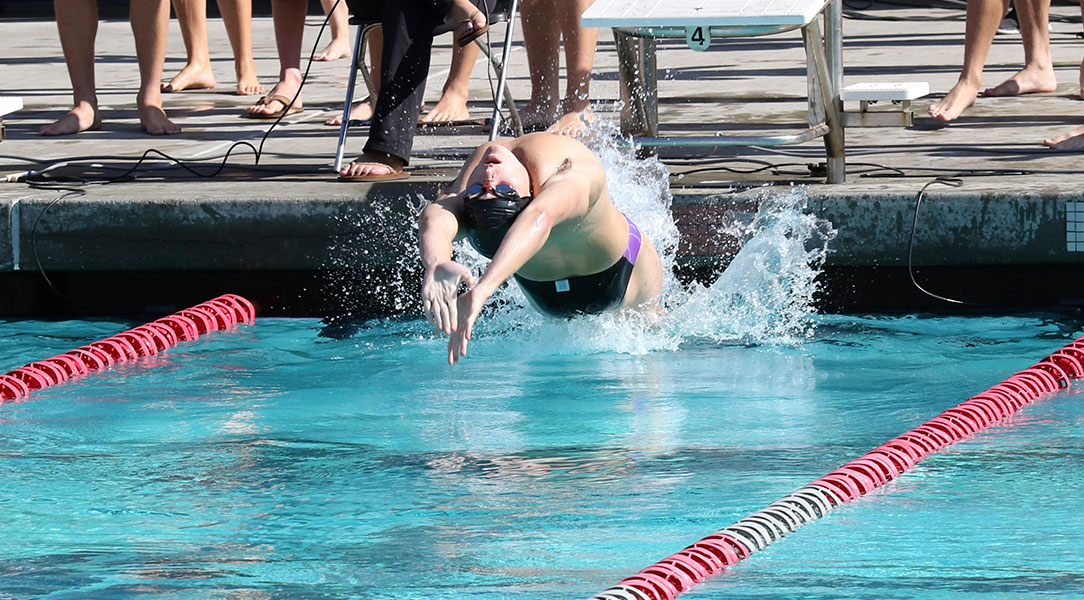 William Crewe pushes off the wall to do backstroke.