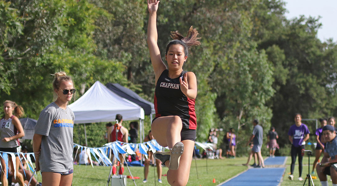 Josie Chan flies through the air during a long jump attempt.