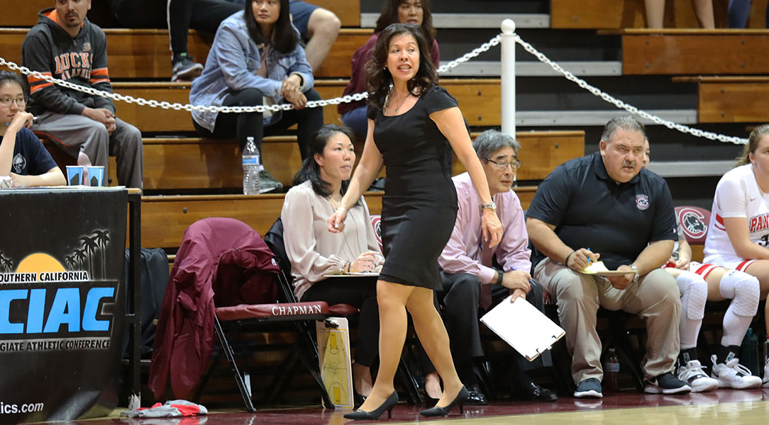 Carol Jue walks on the sideline during a game.
