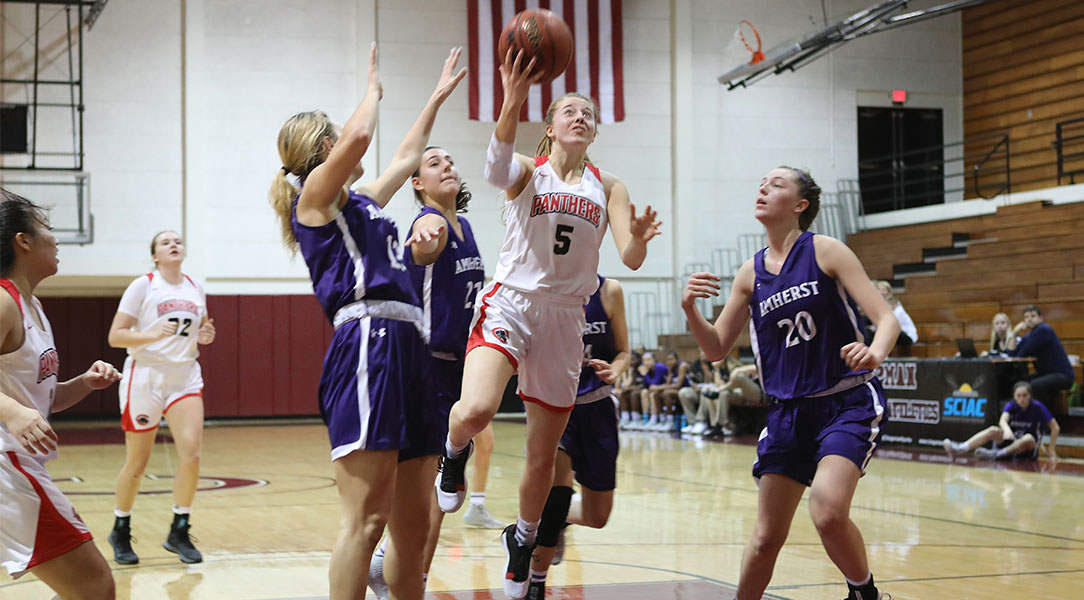 Lucy Criswell shoots a layup between three defenders.