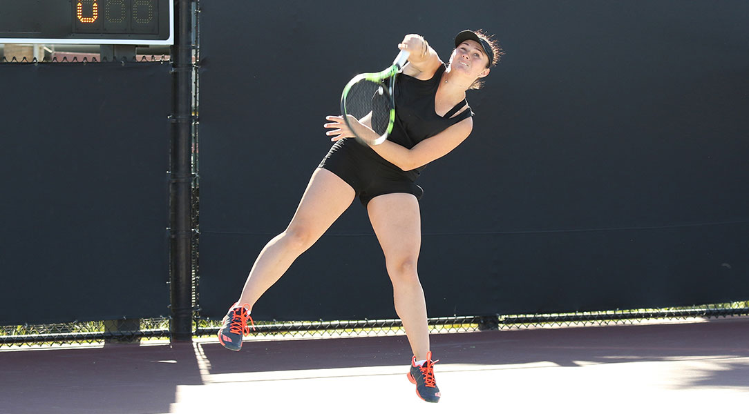 Vasilisa Trofimova follows through on a serve.