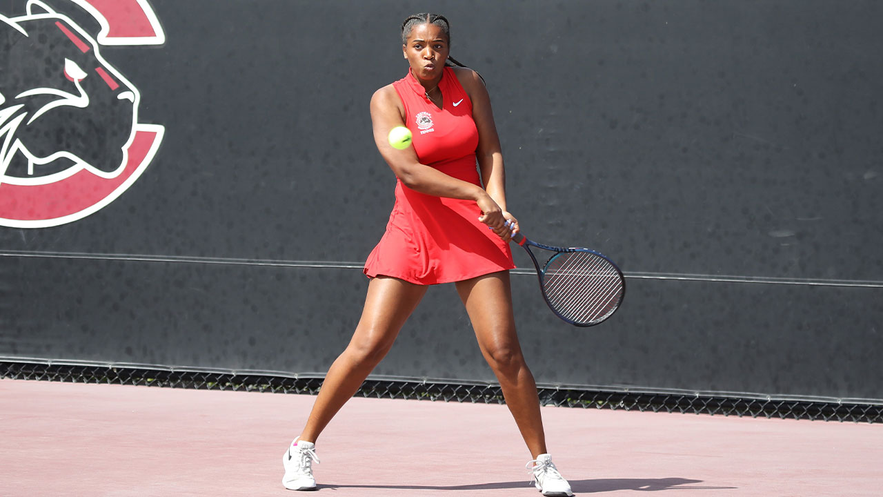 Soleil Zsibrita prepares to hit a back handed tennis shot.