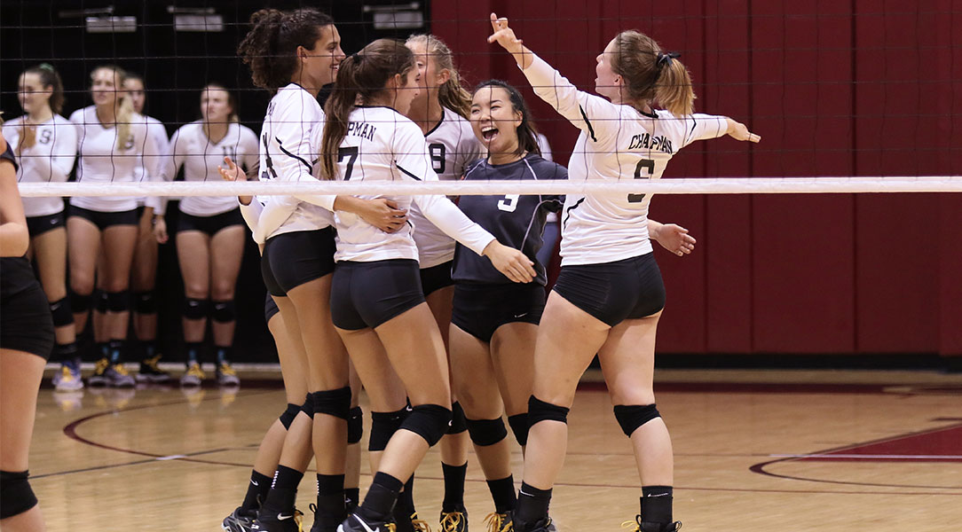 The volleyball team celebrates a point.