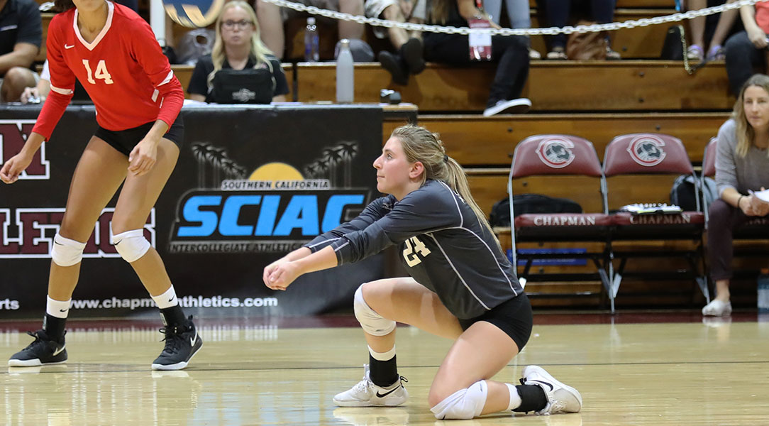 Cat Helgeson kneels to pass a volleyball.