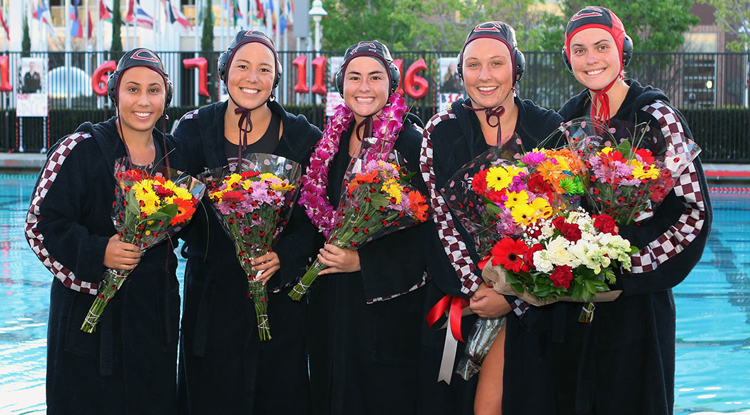 The five Chapman seniors pose for a picture with flowers during Senior Day.