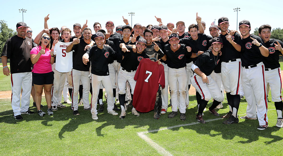 The Chapman baseball team holds up Carter Ankeny and Miguel Cebedo's jerseys.