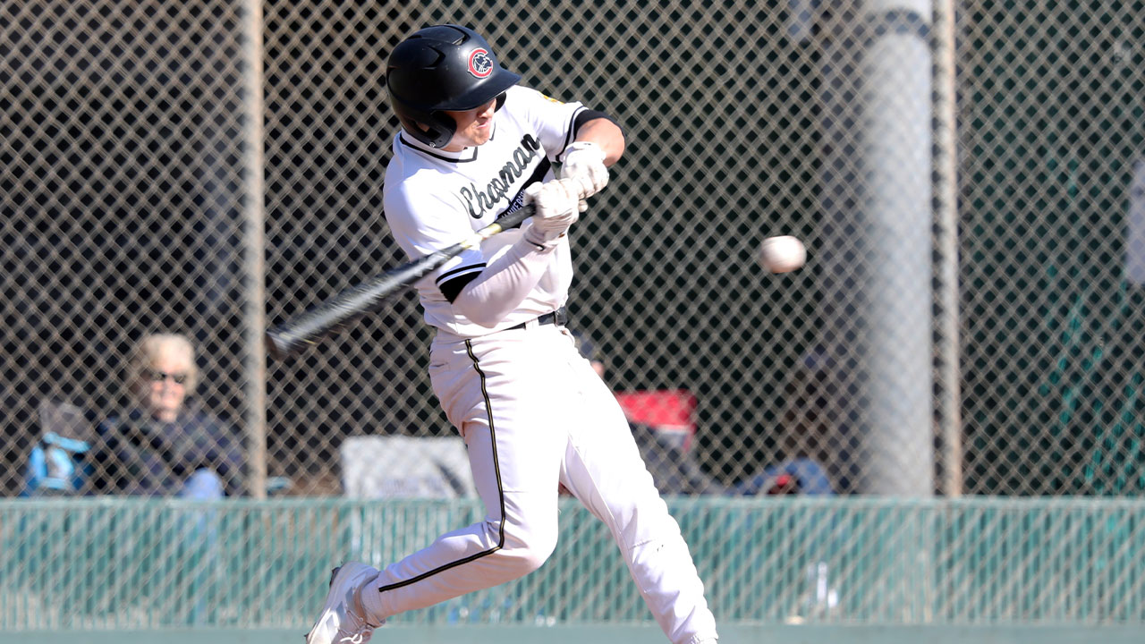 Drew Littwin swings at a baseball.