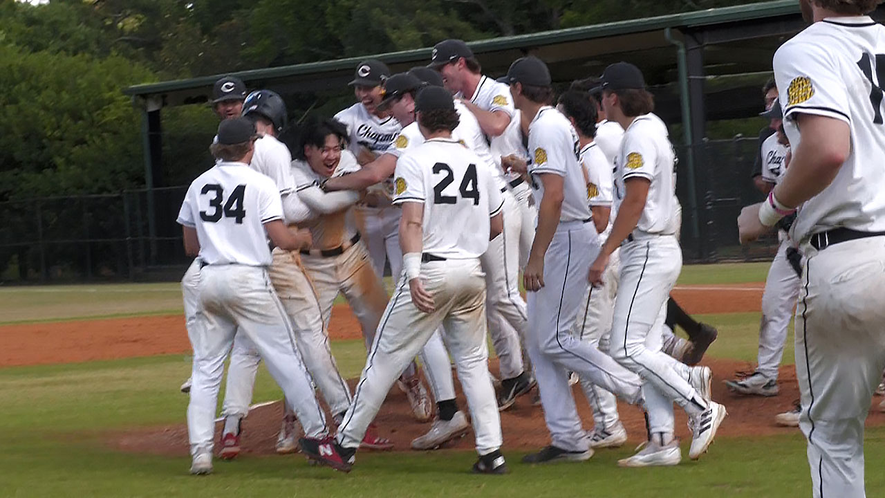 CHapman baseball players celebrate the walkoff victory on the field.