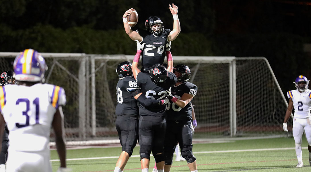 Tanner Mendoza is lifted by teammates after a touchdown.