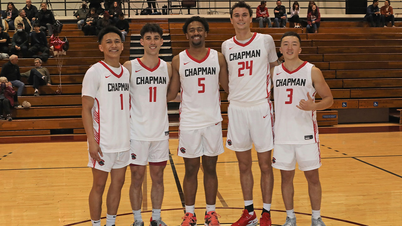 The five seniors of the men's basketball team standing together.