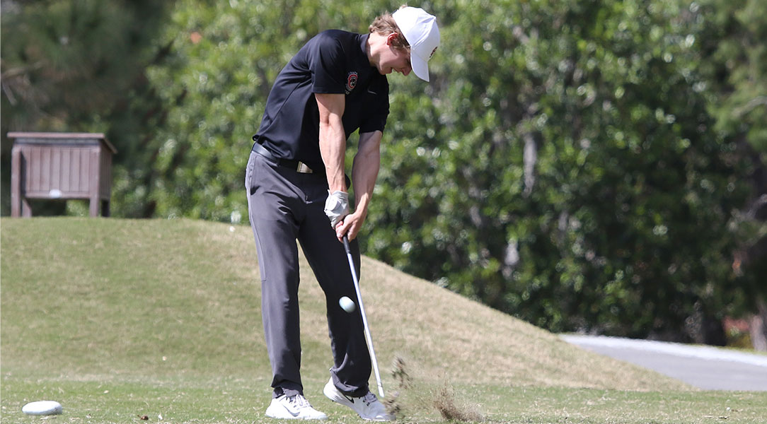 Brody Hval swings the golf club.