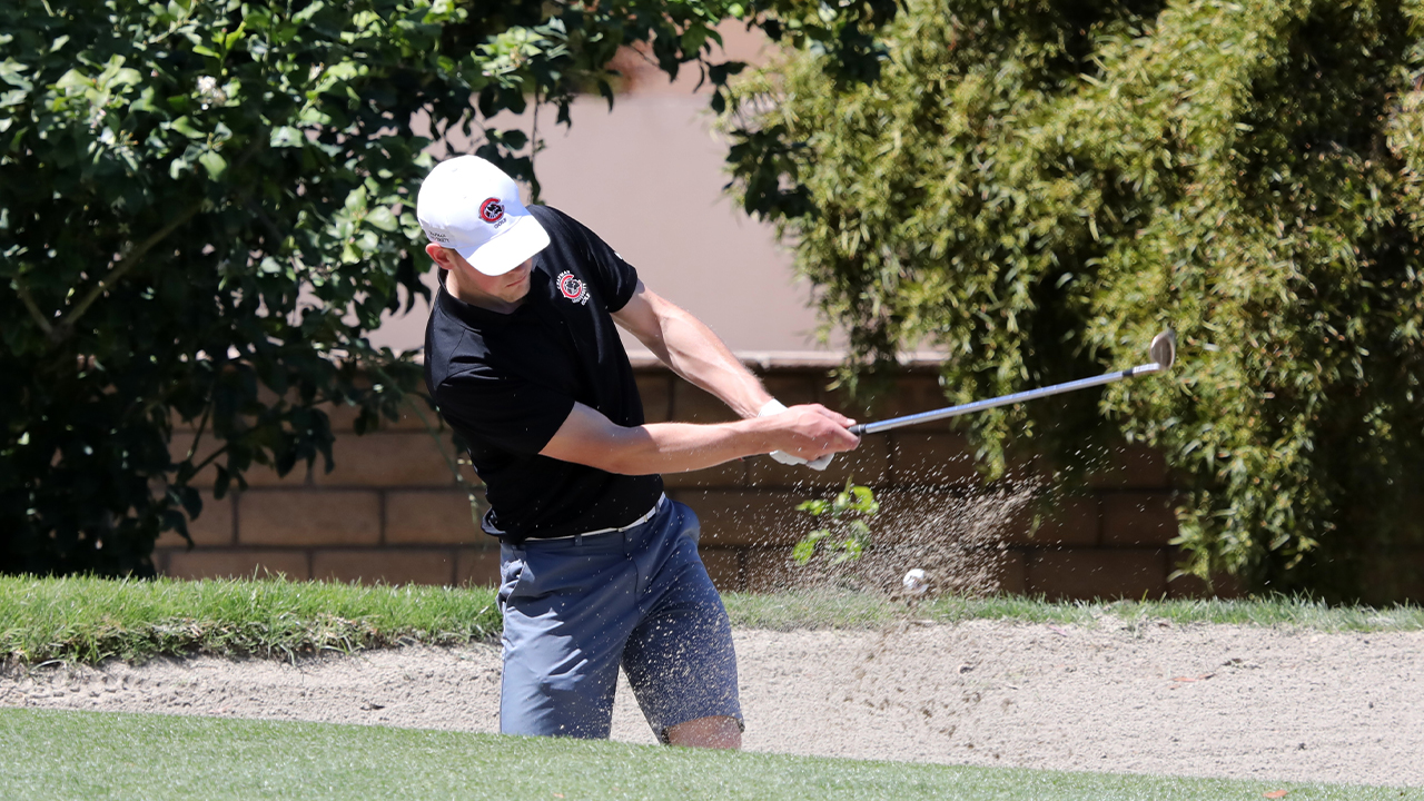 Chapman men's golf player hits the ball out of the dirt 