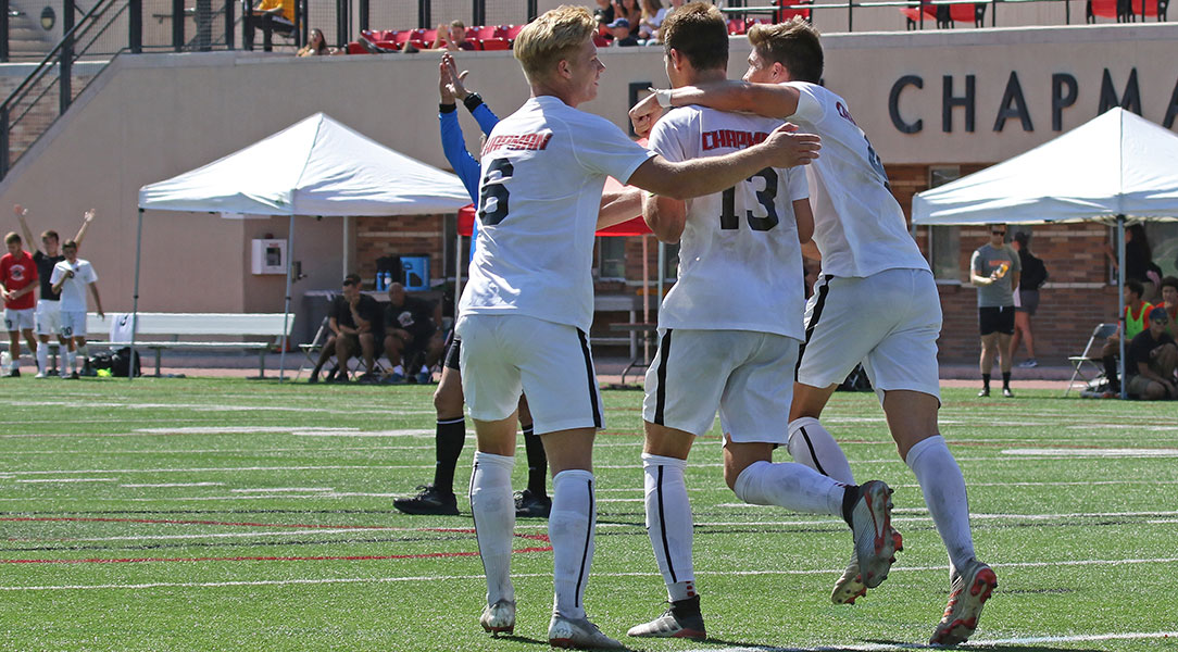 Jarod Matteoni and his teammates celebrate after he scores the game-winning goal.