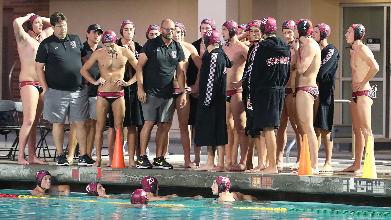 The water polo team comes together on the pool deck.