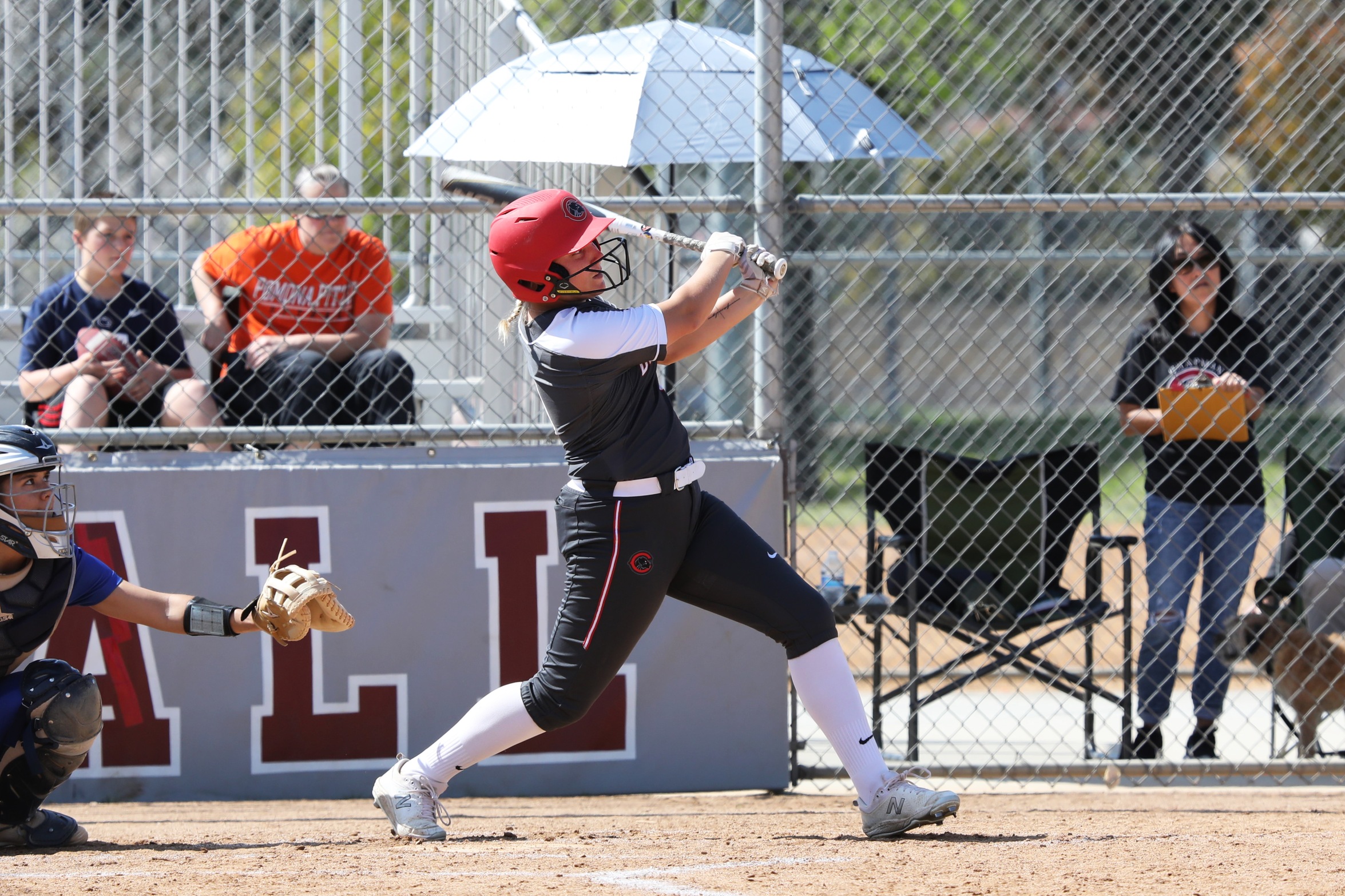 Morgan Lastinger connects on her first career homer (Photo by Larry Newman).