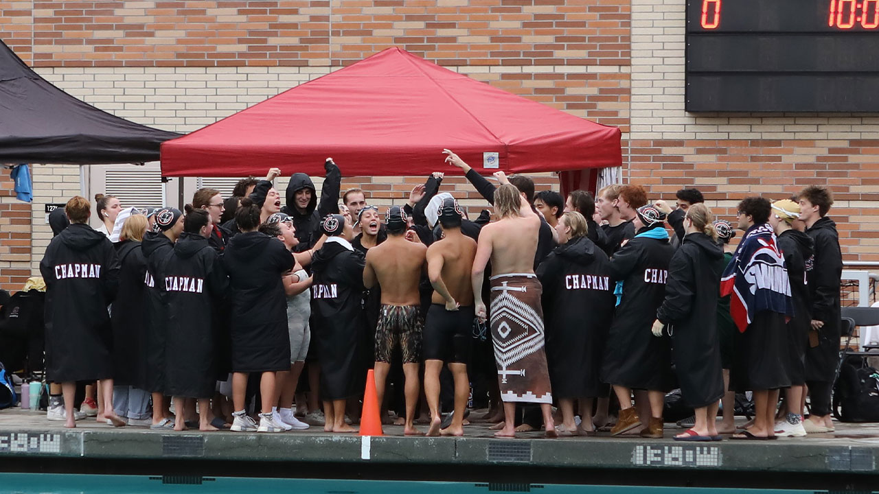 The swim & dive teams in a pre-meet huddle.