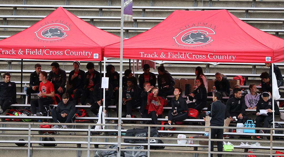 The track & field team sits in the bleachers before a meet.