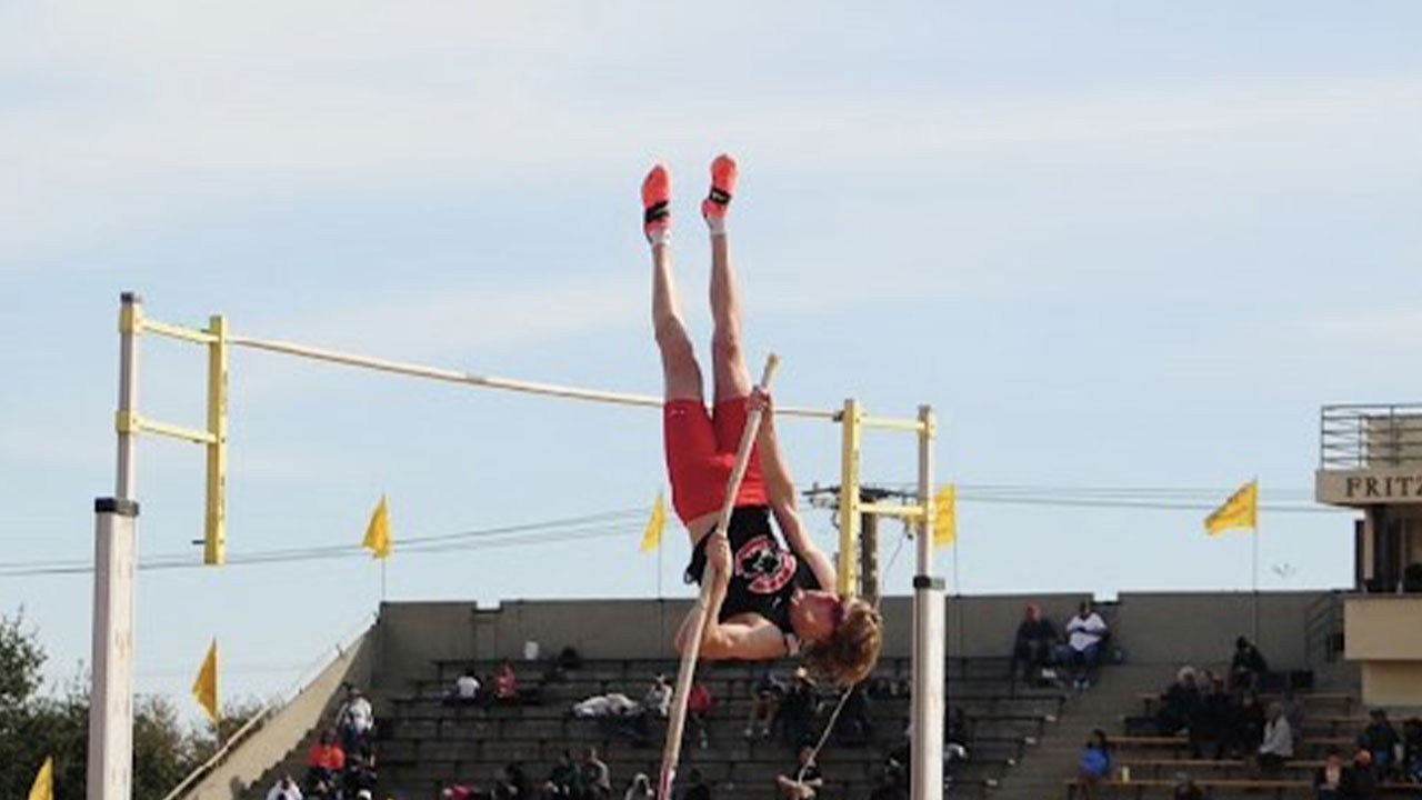 Jesse McMillan pole vaults over the bar.