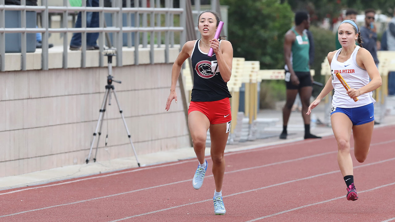 Zoe Zurasky runs with the baton.