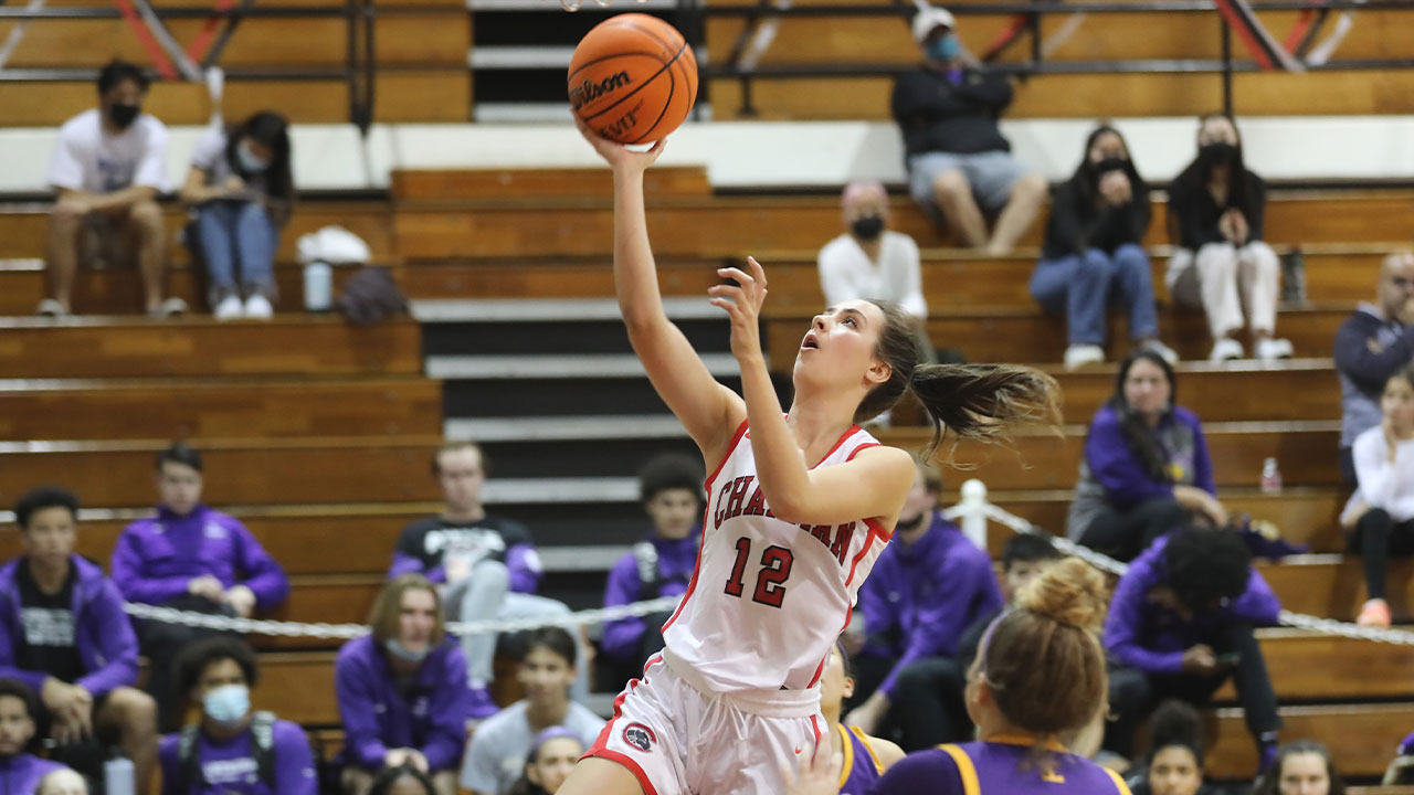 Julia Strand drives and shoots a layup over a defender.