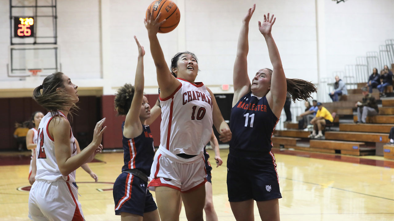 Mia Yamamoto drives in for a layup between two defenders.