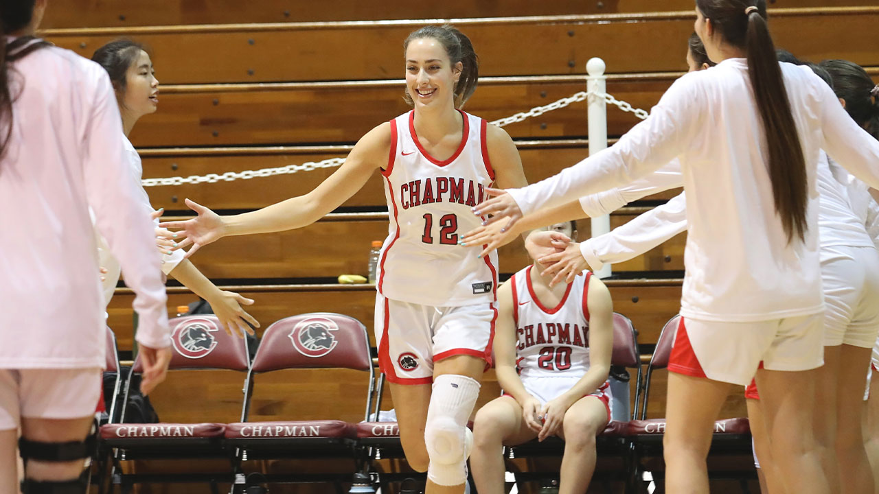 Julia Strand high fives teammates as she is introduced off the bench.