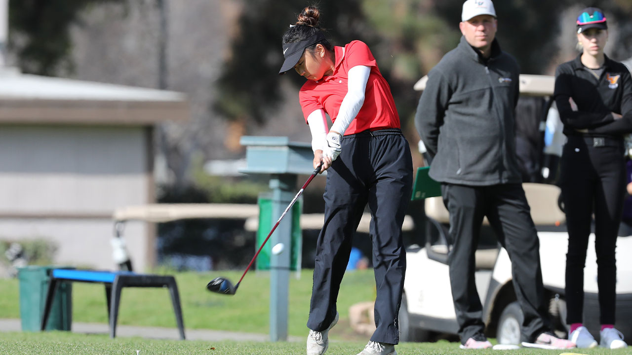 Emily Cho hits a golf ball off the tee.