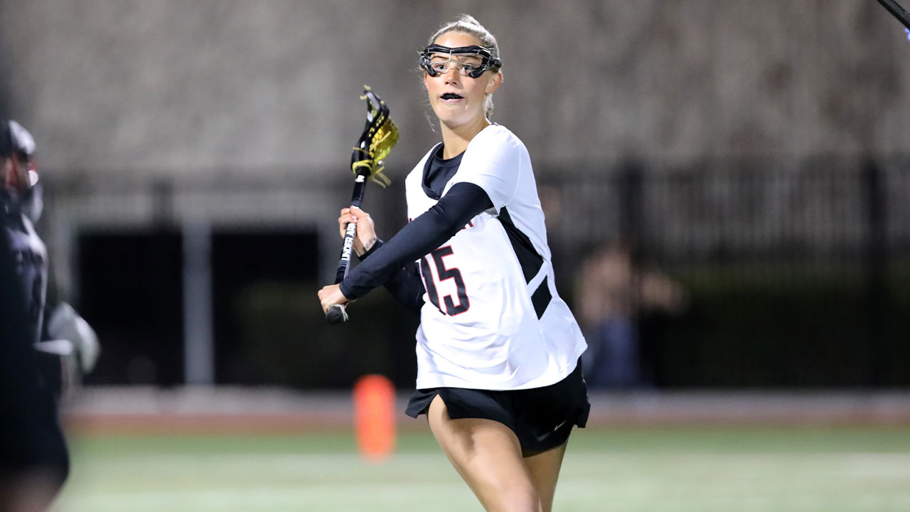 Liv Huntley-Robertson passes the ball to a lacrosse teammate.