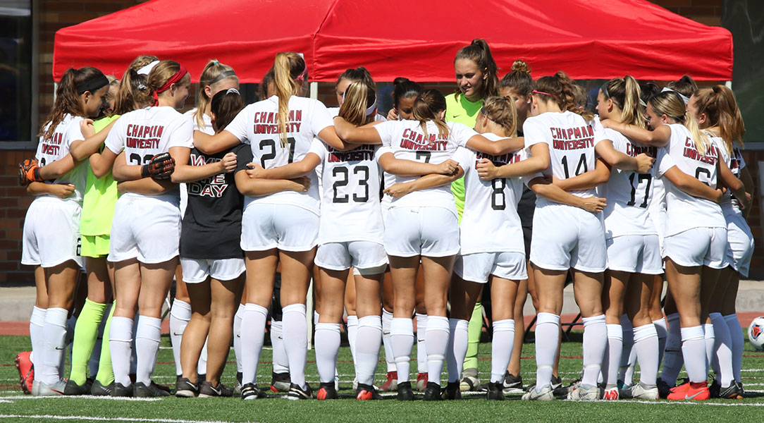 The Chapman women's soccer team huddles before the game.