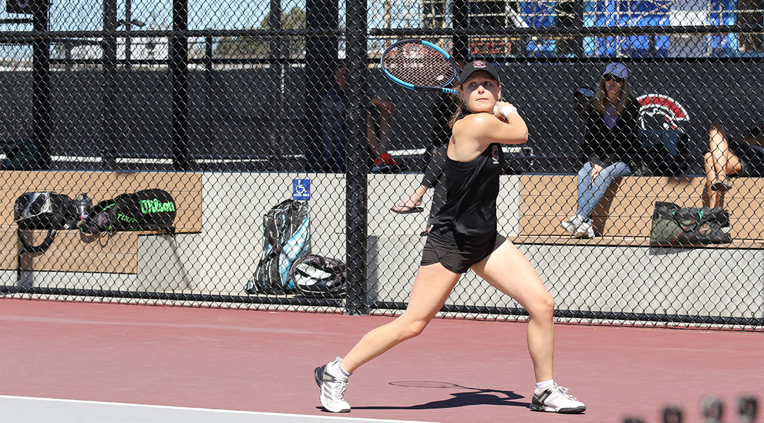 Madison Ross prepares to hit a backhand tennis shot.