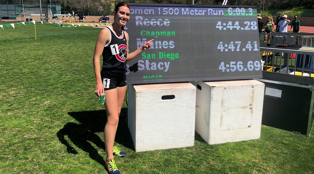 Arabella Reece poses in front of the scoreboard with her school record time.