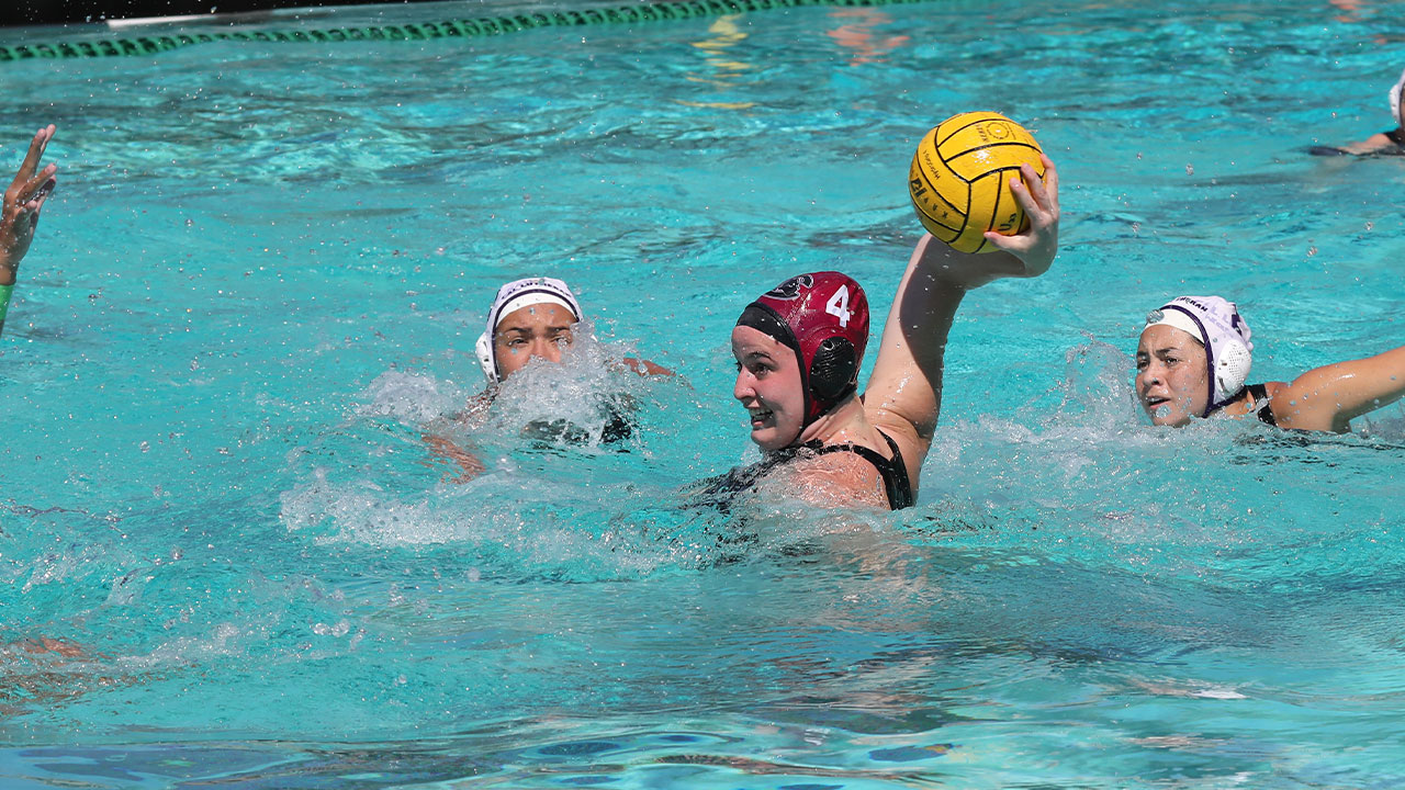 Alyssa Fricker reaches back to take a shot with the water polo ball.