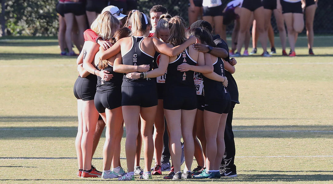 The women's cross country team huddles before the race.