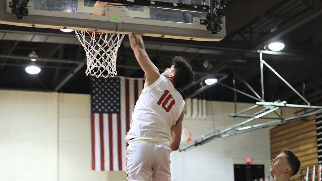 Blakely Stoughton dunks the basketball.