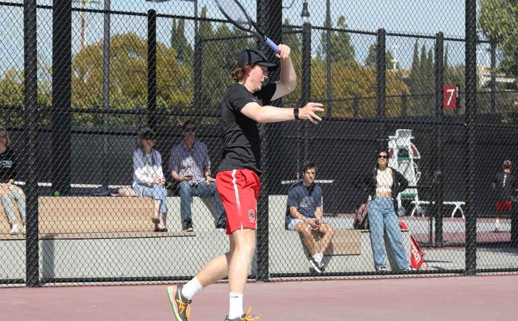 Caleb Wilkins playing tennis.