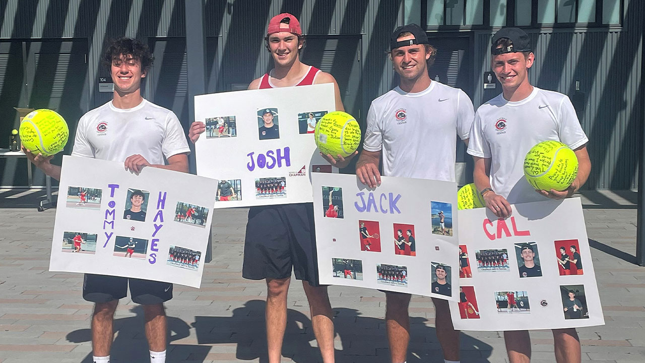 Four Chapman men's tennis seniors hold up signs and signed tennis balls.