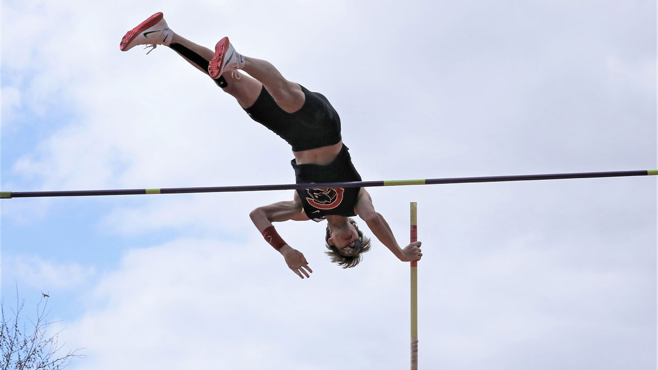 Jesse McMillan pole vaults over the bar.