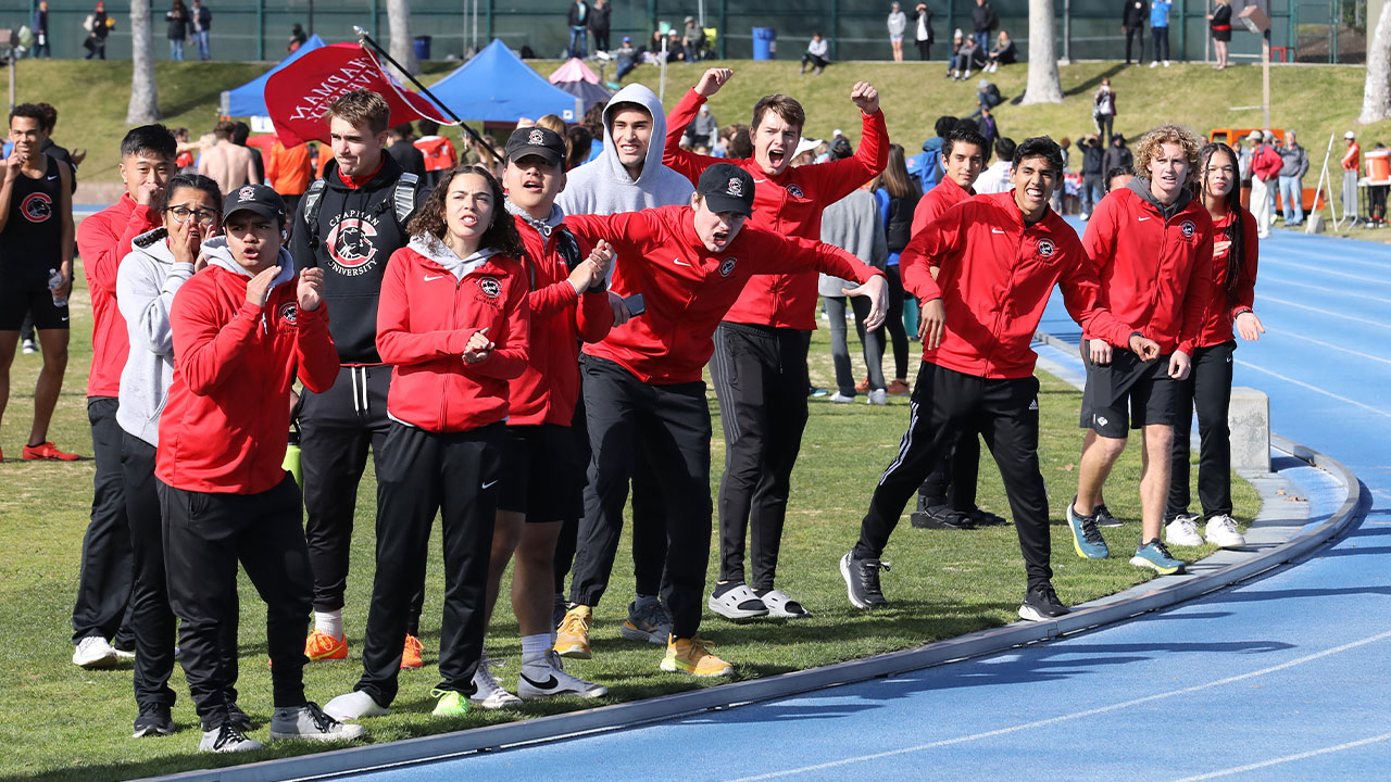 Track & field team members cheer on a relay. 