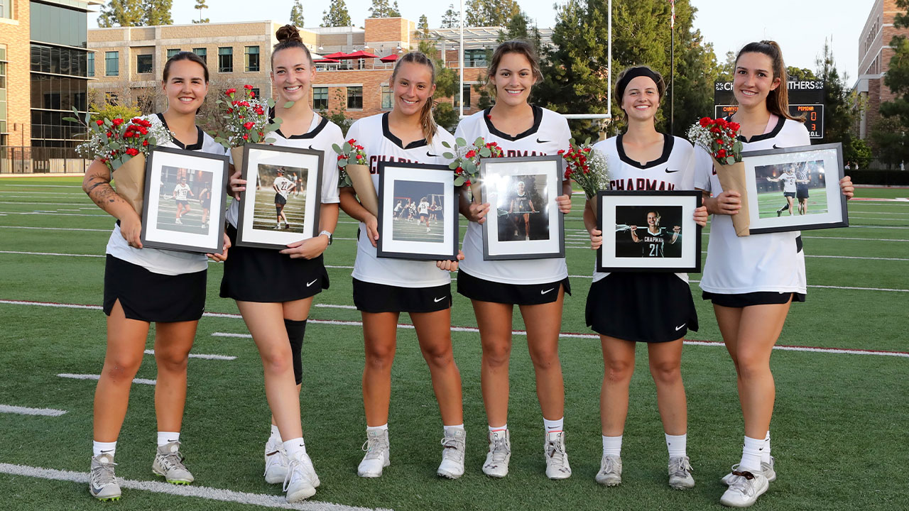 Six women's lacrosse seniors hold up framed pictures.