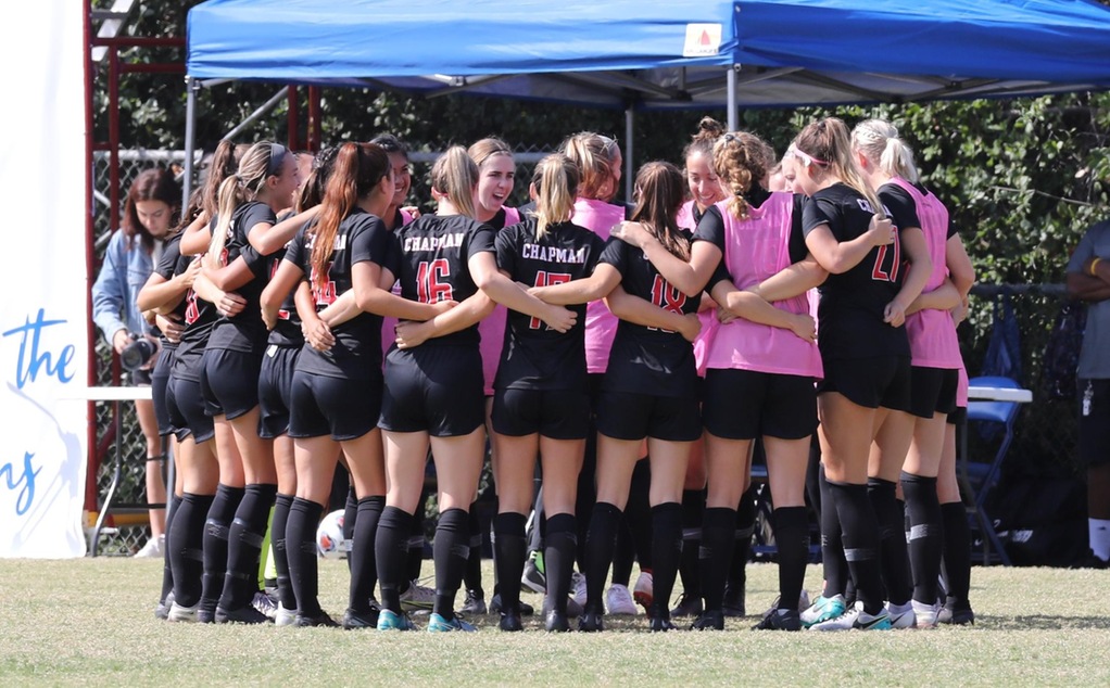 Chapman women's soccer team huddles before a game. 